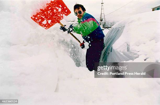 Dan Littlefield of Campe Ellis attempts to clear snow from his car Sunday morning, March 14, 1993. "There was a car around here somewhere," he joked....