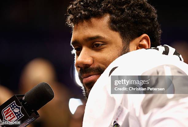 Russell Wilson of the Seattle Seahawks addresses the media at Super Bowl XLIX Media Day Fueled by Gatorade inside U.S. Airways Center on January 27,...