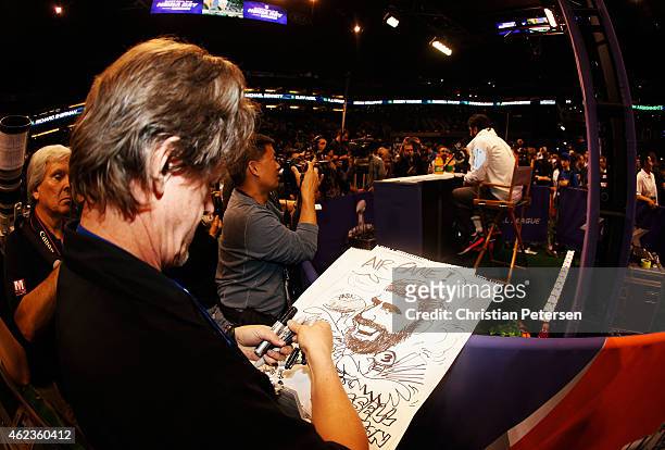 Editorial cartoonist Steve Benson of the Arizona Republic draws Russell Wilson of the Seattle Seahawks at Super Bowl XLIX Media Day Fueled by...