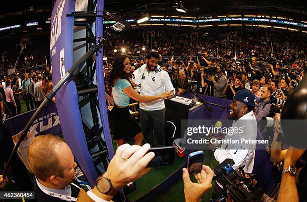 Russell Wilson of the Seattle Seahawks dances at Super Bowl XLIX Media Day Fueled by Gatorade inside U.S. Airways Center on January 27, 2015 in...