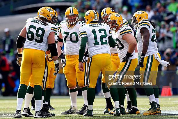 Aaron Rodgers of the Green Bay Packers calls a play in the huddle against the Seattle Seahawks during the 2015 NFC Championship game at CenturyLink...