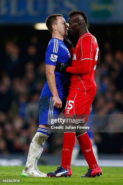 John Terry of Chelsea clashes with Mario Balotelli of Liverpool during the Capital One Cup Semi-Final second leg between Chelsea and Liverpool at...