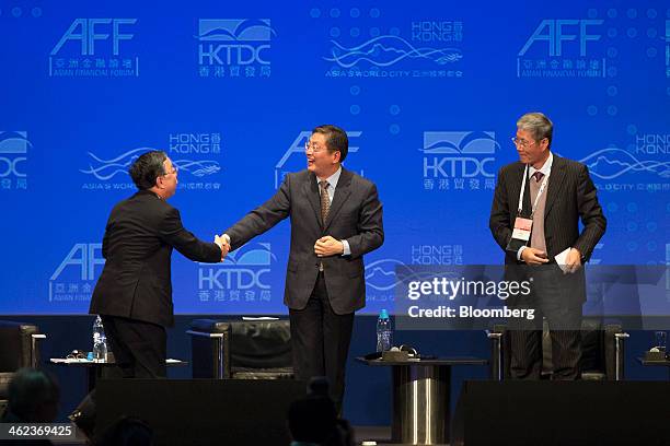 Ronnie Chan, chairman of Hang Lung Properties Ltd., left, shakes hands with Tu Guangshao, former vice mayor of Shanghai, center, as Fu Yuning,...