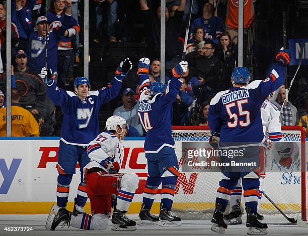 John Tavares, Mikhail Grabovski and Johnny Boychuk of the New York Islanders celebrate a first period goal by Grabovski against the New York Rangers...