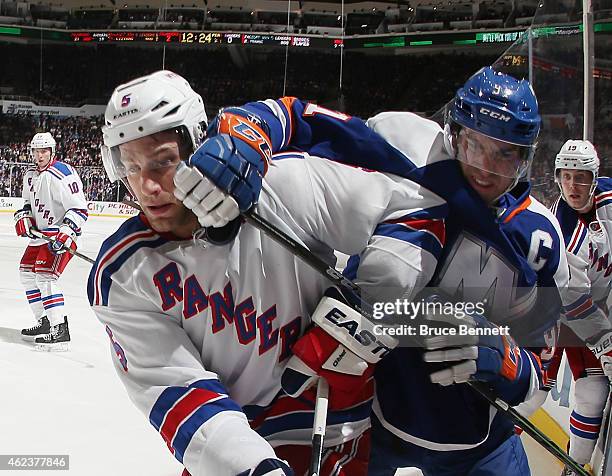 Dan Girardi of the New York Rangers battles with John Tavares of the New York Islanders during the second period at the Nassau Veterans Memorial...