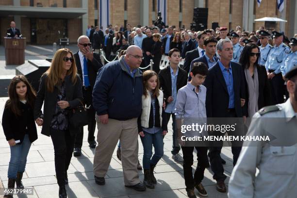 Former Israeli prime minister Ariel Sharon's sons Omri and Gilad walk with their families behind his coffin during a state memorial service at the...