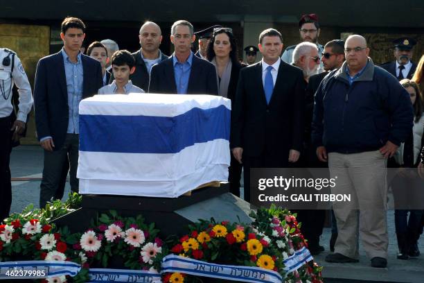 Gilad and Omri Sharon, the sons of the former prime minister Ariel Sharon, stand by his coffin with their families during a state memorial service at...