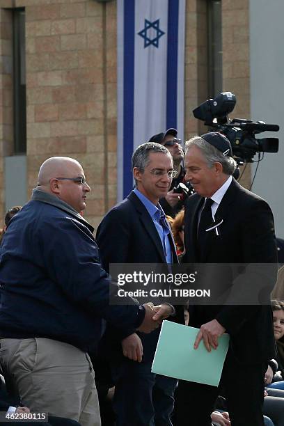 Quartet representative and former British prime minister Tony Blair shakes hand with Gilad and Omri Sharon, the sons of former Israeli prime minister...