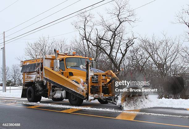 Snow plow works its way along the South Service Road for the Long Island Expressway on January 27, 2015 in Old Westbury. New York. The Long Island...