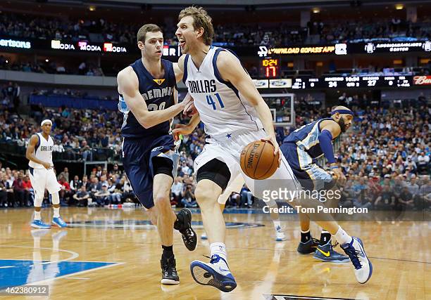 Dirk Nowitzki of the Dallas Mavericks drives to the basket against Jon Leuer of the Memphis Grizzlies in the first half at American Airlines Center...