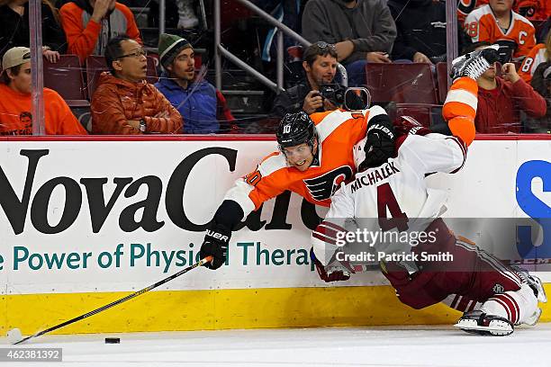 Brayden Schenn of the Philadelphia Flyers is hit by Zbynek Michalek of the Arizona Coyotes in the third period at Wells Fargo Center on January 27,...