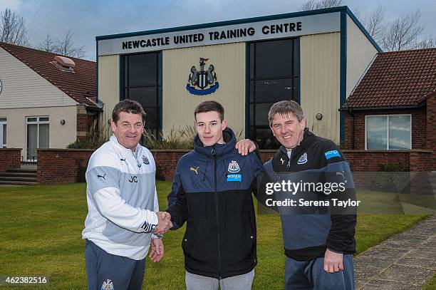 Callum Roberts of Newcastle poses for photographs with head coach John Carver and Football Development Manager Peter Beardsley at The Newcastle...