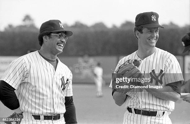 Outfielder Reggie Jackson and pitcher Tommy John of the New York Yankees laugh during Spring Training in March, 1979 at Ft. Lauderdale Stadium in Ft....