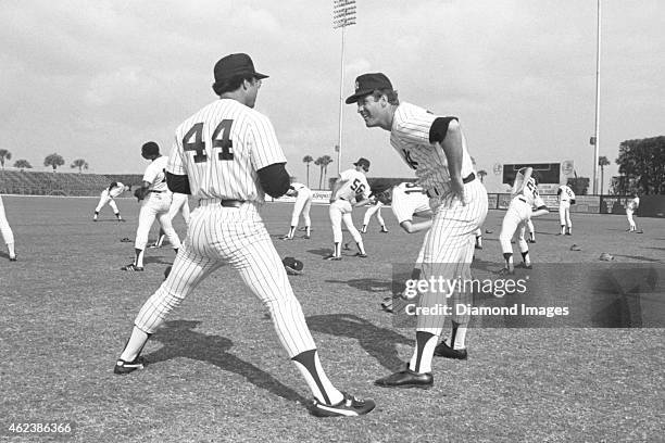 Outfielder Reggie Jackson and pitcher Tommy John of the New York Yankees stretches during Spring Training in March, 1979 at Ft. Lauderdale Stadium in...