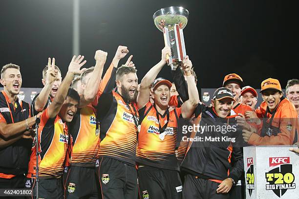 Perth Scorchers players celebrate victory with the Big Bash League trophy after winning the Big Bash League final match between the Sydney Sixers and...