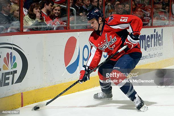 Steve Oleksy of the Washington Capitals controls the puck in the first period during an NHL game against the Carolina Hurricanes at Verizon Center on...
