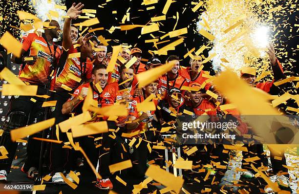 Perth Scorchers players celebrate victory with the Big Bash League trophy after winning the Big Bash League final match between the Sydney Sixers and...