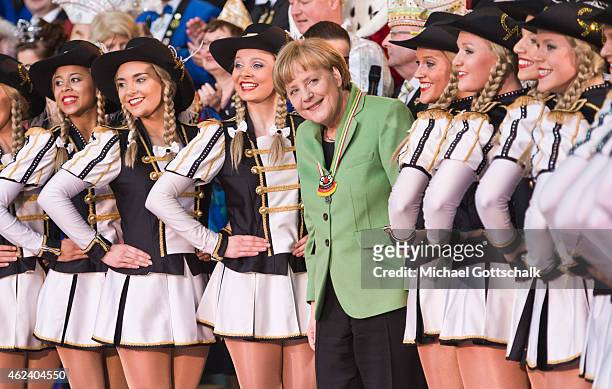 German Chancellor Angela Merkel attends the presentation of a dance of Tanzsportgarde Coburger Mohr during a reception for members of German Carnival...
