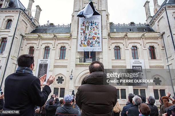 French right-wing UMP party Mayor of Angouleme Xavier Bonnefont claps as a banner is unveiled on the facade of the Hotel de Ville of Angouleme,...