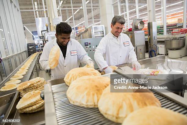 Mathujan Jeyarajan and Mohamad El shakra make fresh pita in a glass enclosure situated at the centre of Marché Adonis in Scarborough. The supermarket...