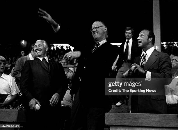 Hall of Famers Bob Feller and Stan Musial flank Major Leabue Baseball Commissioner Bowie Kuhn as Kuhn tosses out the first pitch prior to the...