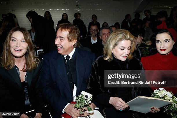 Carla Bruni-Sarkozy, Gilles Dufour, Catherine Deneuve and Dita von Teese attend the Jean Paul Gaultier show as part of Paris Fashion Week Haute...