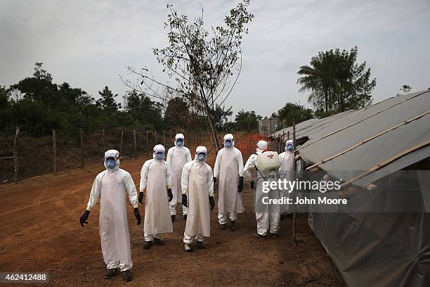 Burial team awaits decontamination at the U.S.-built cemetery for "safe burials" on January 27, 2015 in Disco Hill, Liberia. The cemetery, operated...