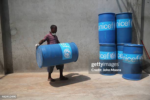 Workers assemble "school infection prevention kits" to stop the spread of Ebola in schools scheduled to open next week on January 28, 2015 in...