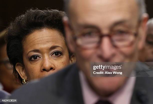 Attorney for the Eastern District of New York Loretta Lynch listens as U.S. Sen. Charles Schumer testifies for her during a confirmation hearing...