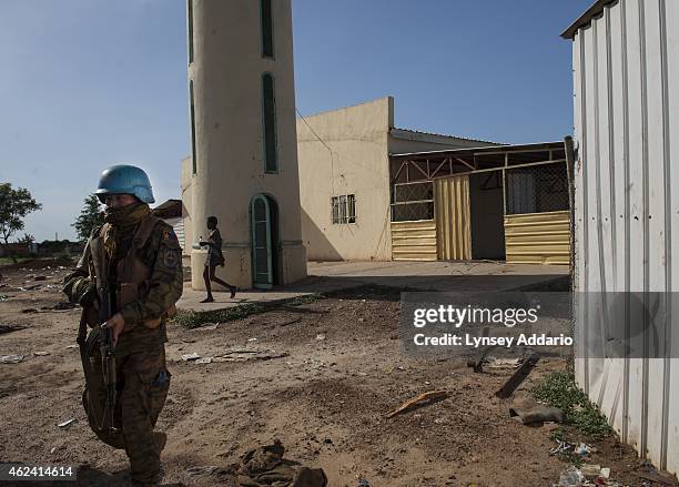 United Nations Peacekeeper walks through the remnants of the massacre at the mosque in Bentiu, where hundreds were killed while taking refuge from...