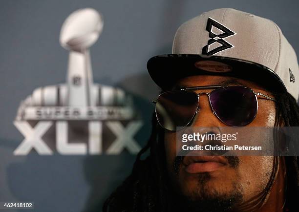 Running back Marshawn Lynch of the Seattle Seahawks sits at his podium during a Super Bowl XLIX media availability at the Arizona Grand Hotel on...
