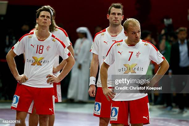 Hans Lindberg and Anders Eggert of Denmark look dejected after the quarter final match between Spain and Denmark at Lusail Multipurpose Hall on...