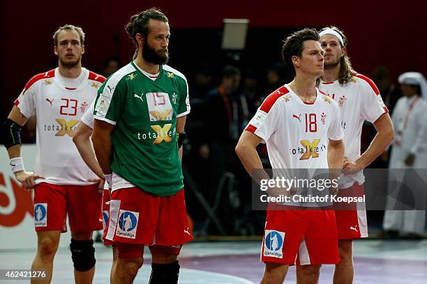 Henrik Toft, Jesper Noeddesbo, Hans Lindberg and Mikkel Hansen of Denmark look dejected after the quarter final match between Spain and Denmark at...