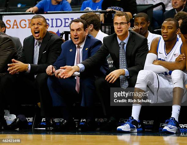 Head coach Mike Krzyzewski, center, of the Duke Blue Devils reacts to a call along with assistants Jeff Capel, left, and Jon Scheyer, right, in the...