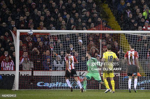 Sheffield United's English goalkeeper Mark Howard looks on as the free kick from Tottenham Hotspur's Danish midfielder Christian Eriksen cannons onto...