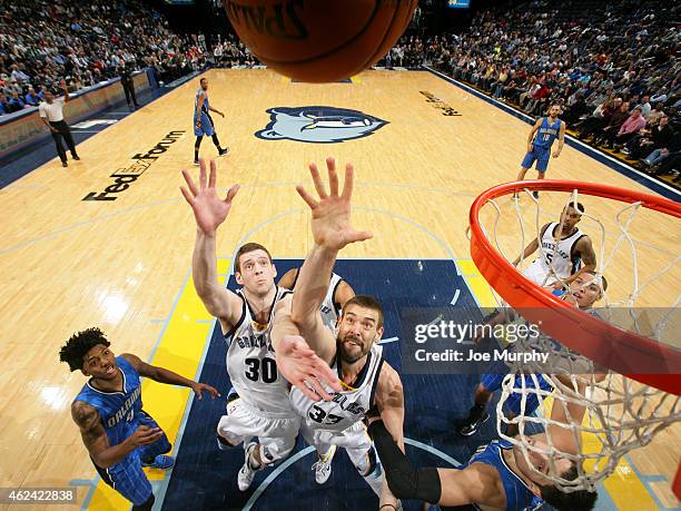 Jon Leuer and Marc Gasol of the Memphis Grizzlies grabs the rebound against the Orlando Magic on January 26, 2015 at FedExForum in Memphis,...