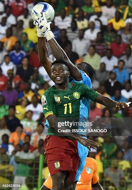 Ivory Coast's goalkeeper Sylvain Gbohouo catches the ball as Cameroon's midfielder Edgar Salli attempts to score during the 2015 African Cup of...