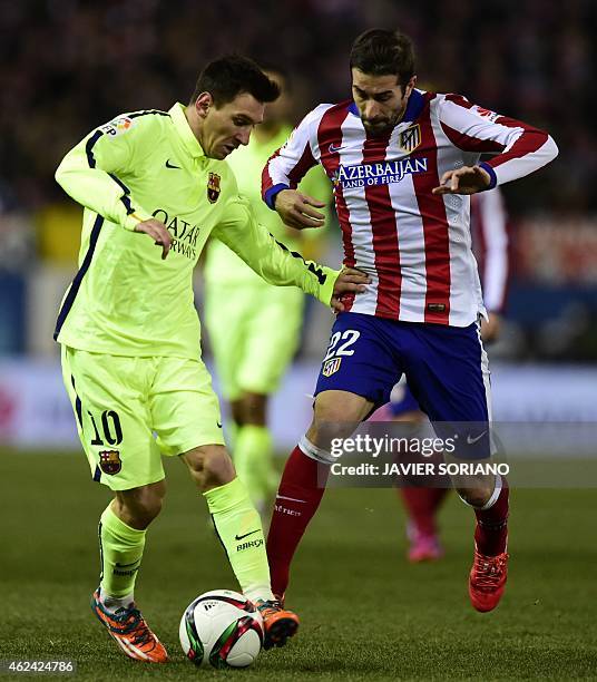 Barcelona's Argentinian forward Lionel Messi vies with Atletico Madrid's midfielder Cani during the Spanish Copa del Rey quarter final second leg...