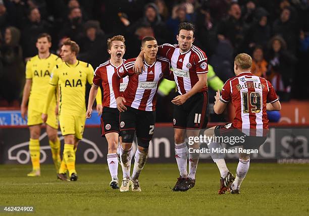 Che Adams of Sheffield United celebrates scoring his second goal with team mates during the Capital One Cup Semi-Final Second Leg match between...