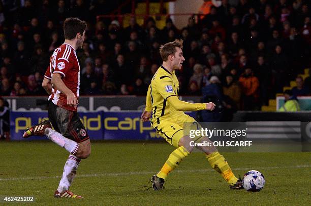 Tottenham Hotspur's Danish midfielder Christian Eriksen slots home his second and his team's second goal during the English League Cup semi-final...