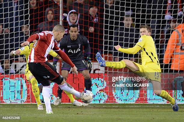 Sheffield United's English forward Che Adams scores his second and his team's second goal as Tottenham Hotspur's English defender Eric Dier tries to...