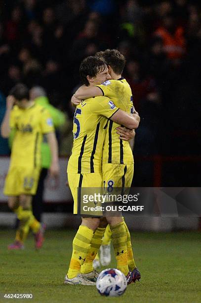 Tottenham Hotspur's French midfielder Benjamin Stambouli embraces Tottenham Hotspur's English midfielder Ryan Mason as they celebrate their victory...