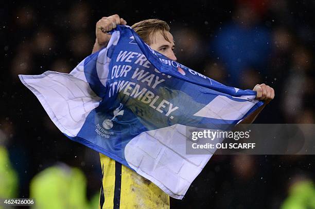 Tottenham Hotspur's English striker Harry Kane celebrates his team's victory after the final whistle in the English League Cup semi-final second leg...