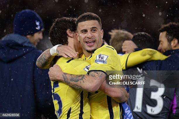 Tottenham Hotspur's English defender Kyle Walker embraces Tottenham Hotspur's French midfielder Benjamin Stambouli as Tottenham players celebrate...