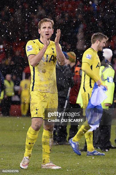 Tottenham Hotspur's English striker Harry Kane applauds as Tottenham players celebrate their victory after the final whistle in the English League...