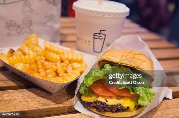 In this photo illustration a cheeseburger and french fries are served up at a Shake Shack restaurant on January 28, 2015 in Chicago, Illinois. The...