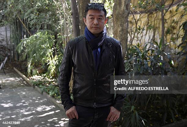 Chinese artist Liu Bolin gestures during an interview at the Fundacion Pedro Meyer in Mexico City on January 28, 2015. AFP PHOTO /ALFREDO ESTRELLA