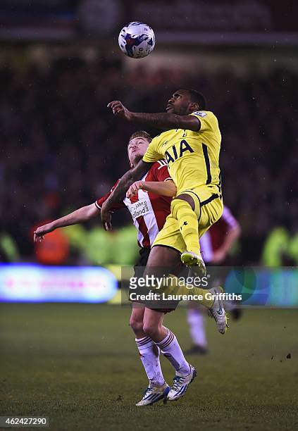 Danny Rose of Tottenham Hotspur wins a header with Louis Reed of Sheffield United during the Capital One Cup Semi-Final Second Leg match between...