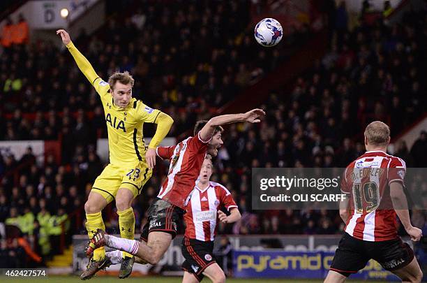 Tottenham Hotspur's Danish midfielder Christian Eriksen beats Sheffield United's Scottish midfielder Ryan Flynn in the air during the English League...