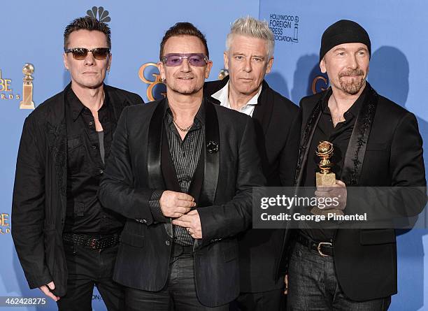 Musicians Larry Mullen Jr., Adam Clayton, Bono, and The Edge of U2 pose in the press room during the 71st Annual Golden Globe Awards held at The...